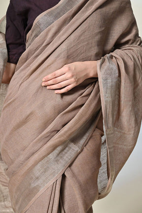 Elegant rust grey, 6.5 mtr. long brown linen saree naturally dyed with catechu, promoting sustainable and organic fashion.