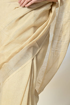 Eco-conscious light yellow linen saree with natural pomegranate dye, part of biodegradable fashion range, dry clean to maintain quality